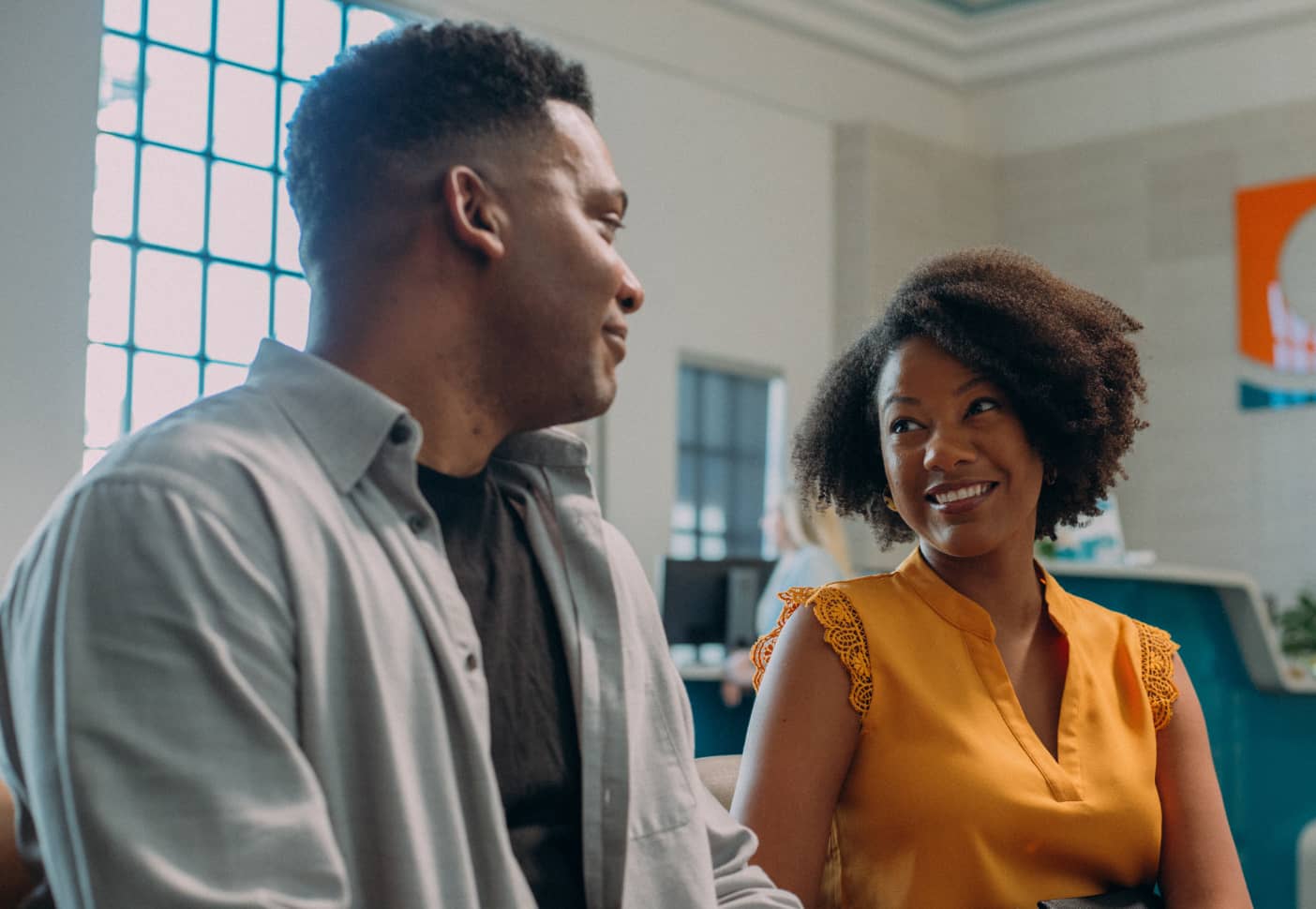 A couple inside a bank discussing their future
