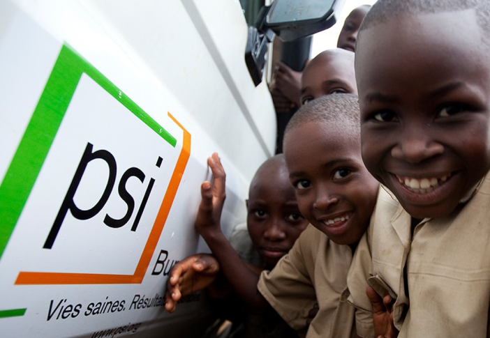 Kids in front of PSI sign